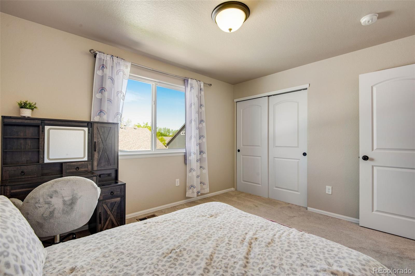 7035 McClellan Road Wellington, CO 80549 - Photo 35 of 43 a bedroom with a bed and wooden floor