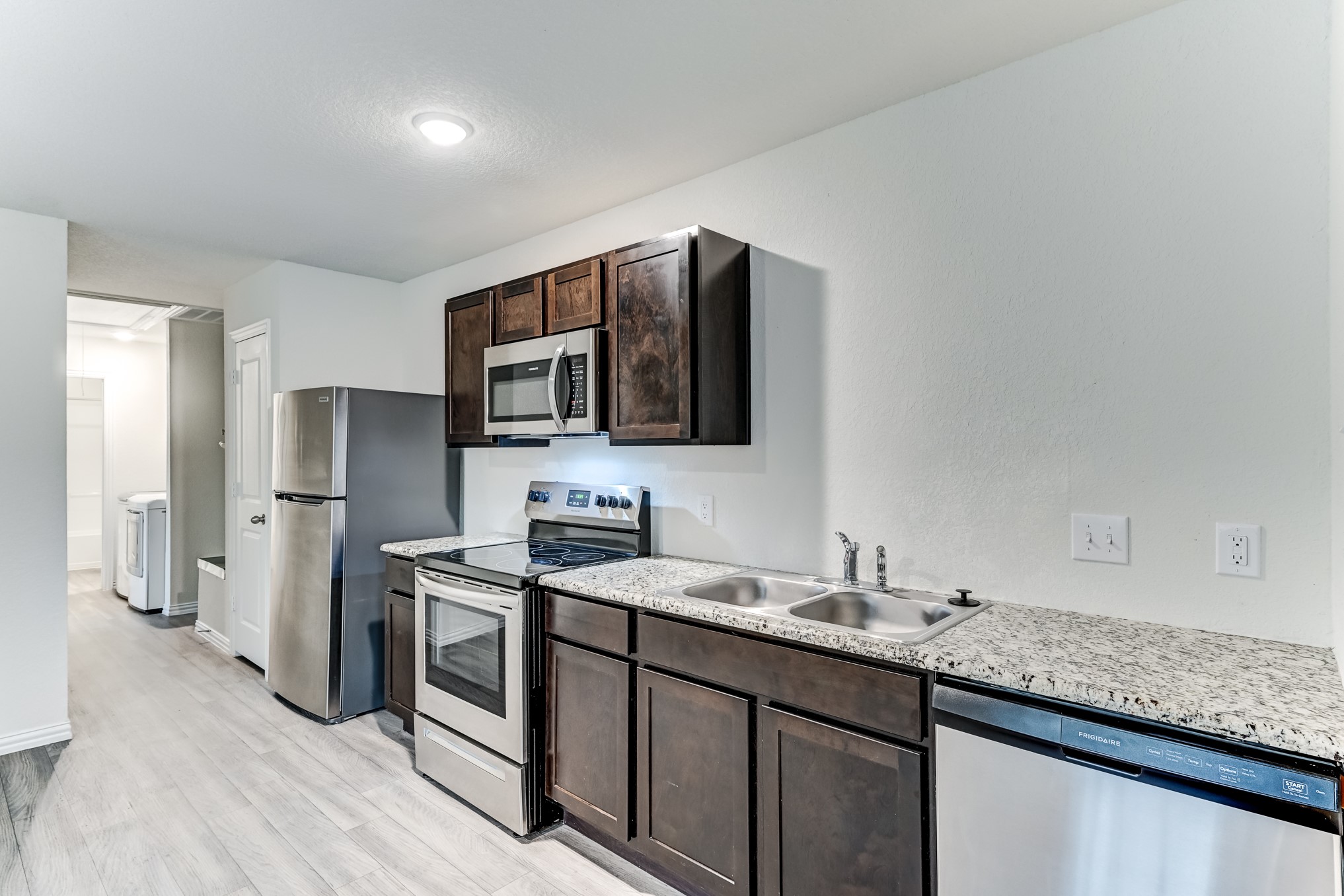 7925 Way Street, Unit A Houston, TX 77028 - Photo 11 of 29 a kitchen with stainless steel appliances granite countertop a sink stove and refrigerator