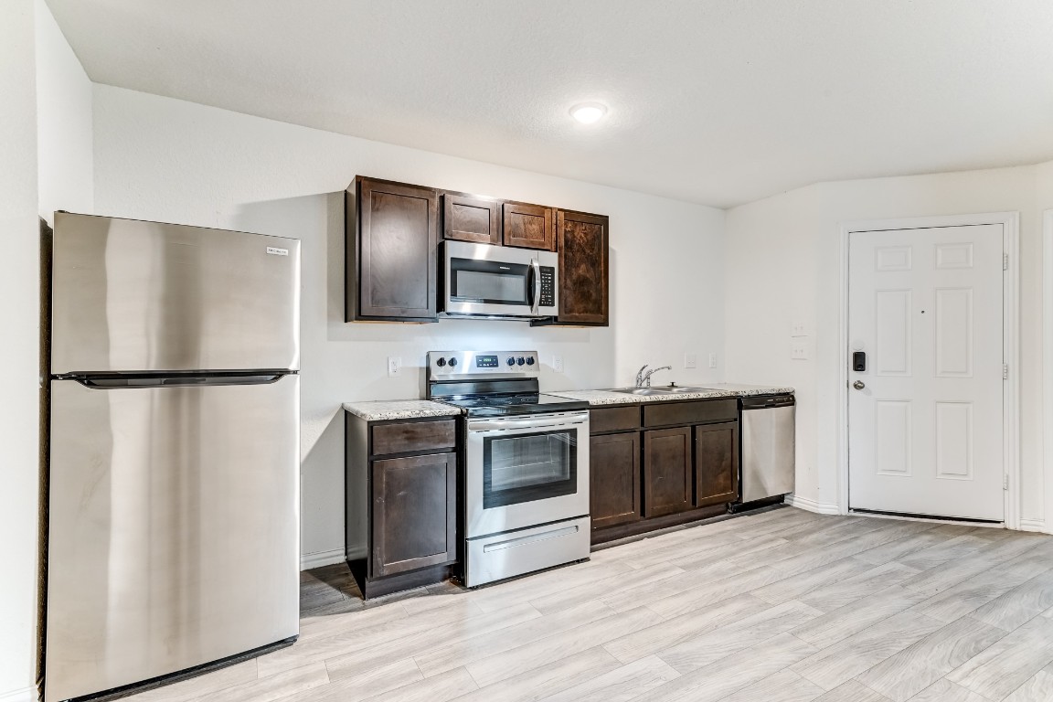 7925 Way Street, Unit A Houston, TX 77028 - Photo 12 of 29 a kitchen with stainless steel appliances granite countertop a refrigerator stove and sink