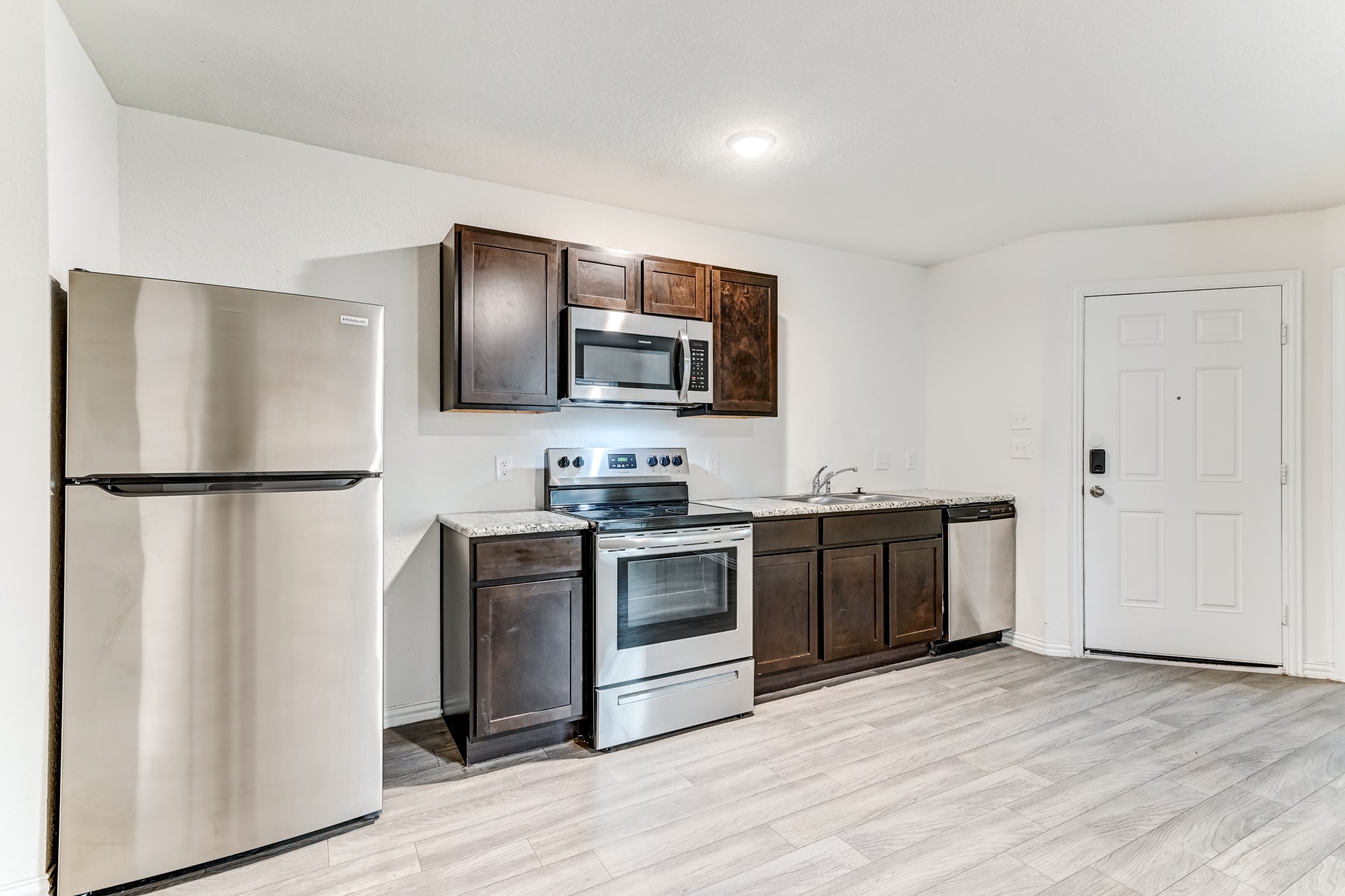 7925 Way Street, Unit A Houston, TX 77028 - Photo 12 of 29 a kitchen with stainless steel appliances granite countertop a refrigerator stove and sink