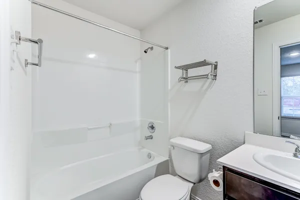 a bathroom with a sink a toilet and a bathtub