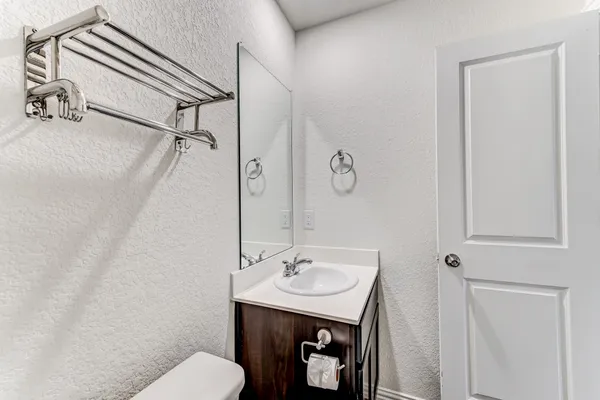 a bathroom with a toilet a sink and mirror