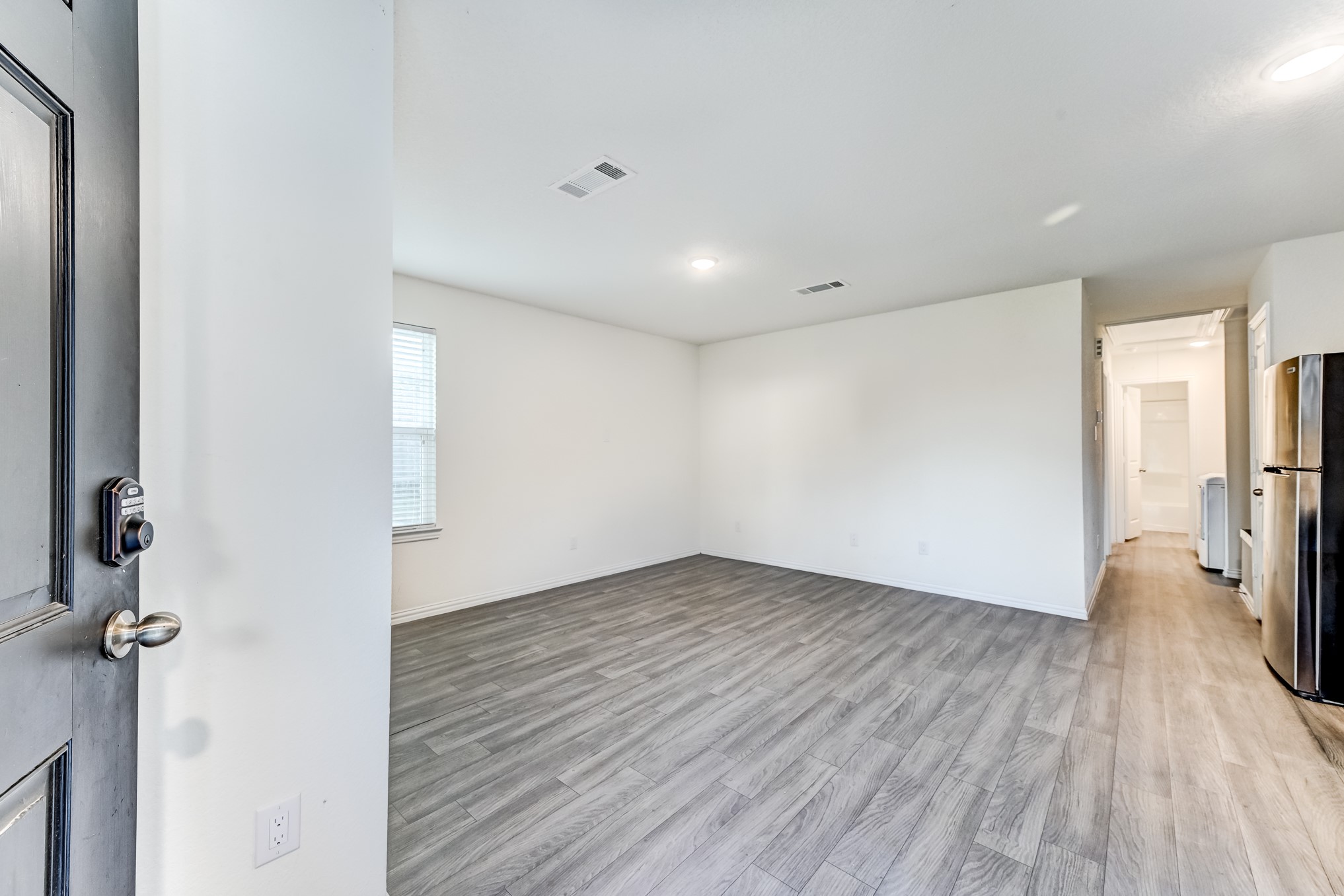 7925 Way Street, Unit A Houston, TX 77028 - Photo 5 of 29 a view of a big room with wooden floor and a hallway