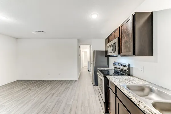 a kitchen with a sink a stove and refrigerator