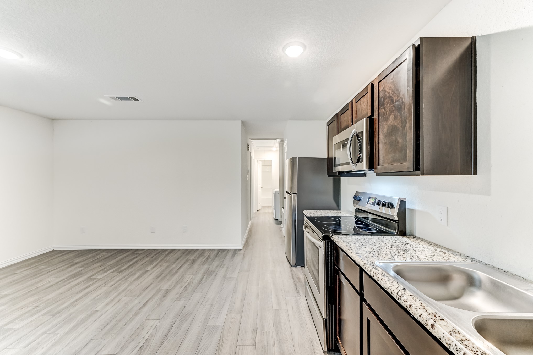 7925 Way Street, Unit A Houston, TX 77028 - Photo 10 of 29 a kitchen with stainless steel appliances granite countertop a sink stove and refrigerator