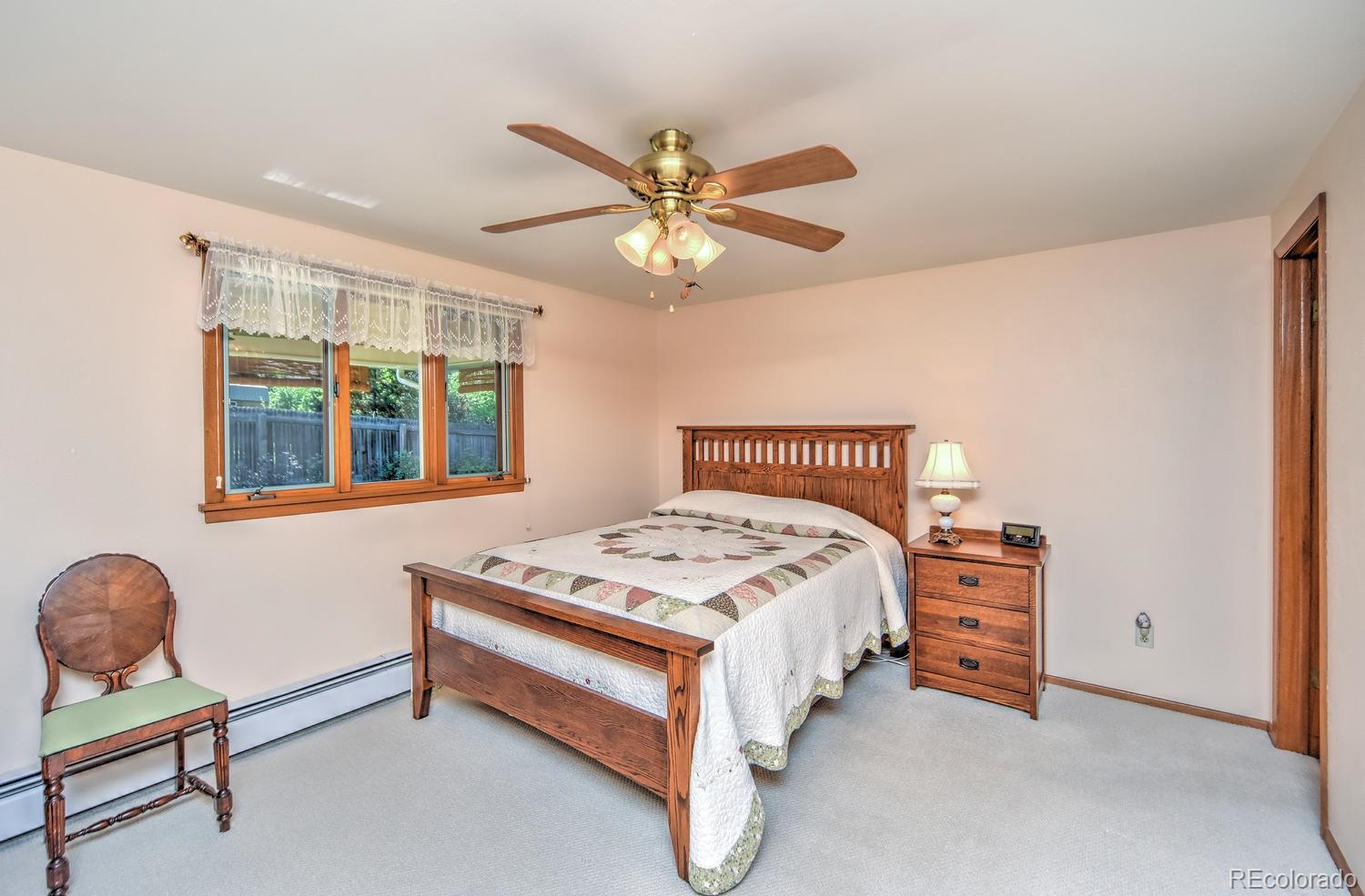 2219 Riviera Place Longmont, CO 80501 - Photo 13 of 19 a bedroom with a bed and a chandelier