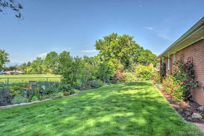 2219 Riviera Place Longmont, CO 80501 - Photo 18 of 19 a view of a garden with a lake