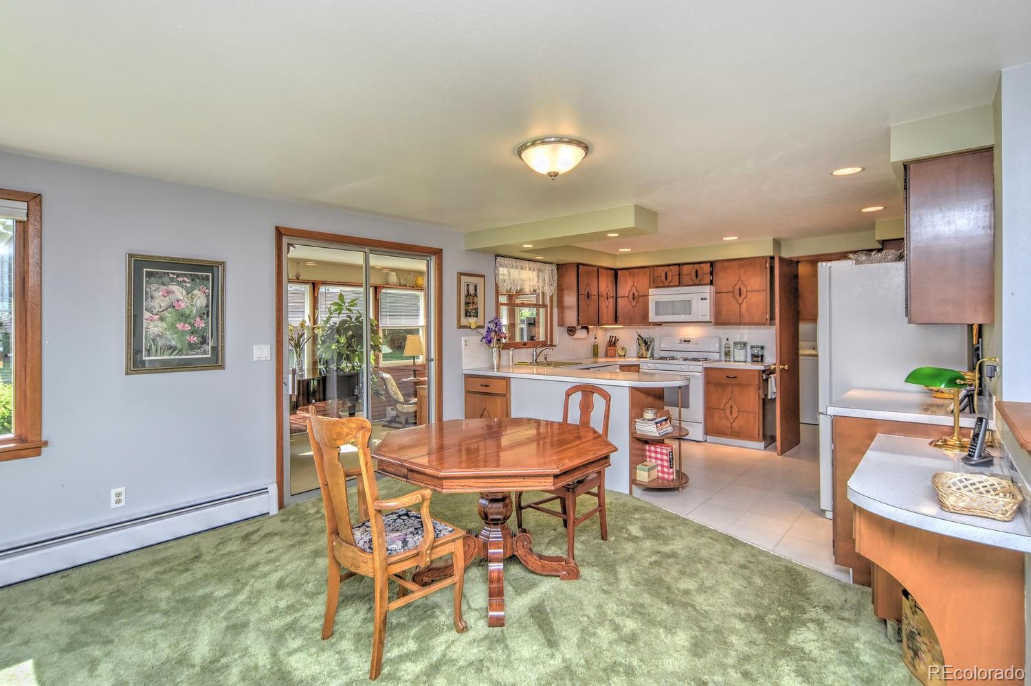 2219 Riviera Place Longmont, CO 80501 - Photo 5 of 19 a living room with dining room and wooden floor