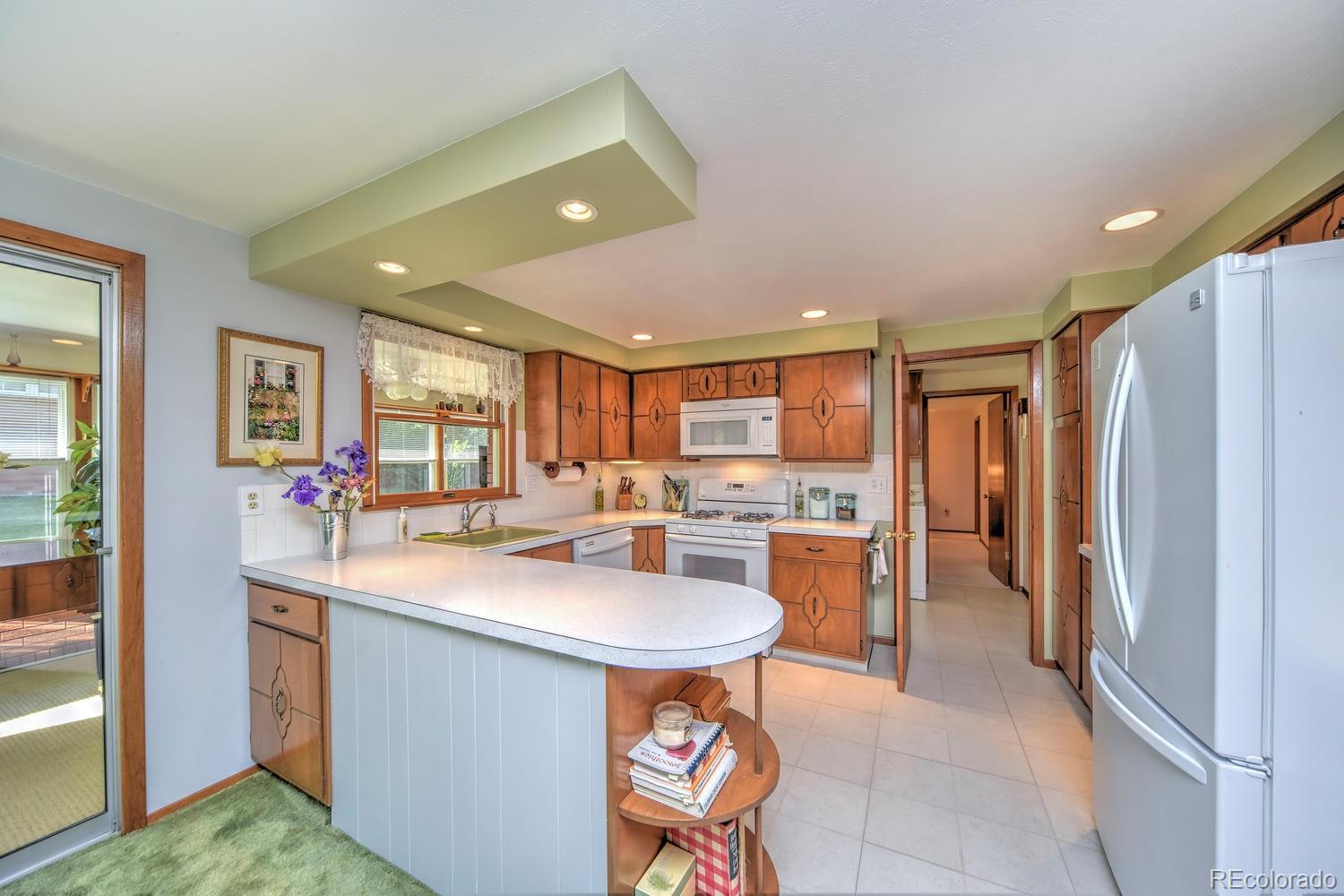 2219 Riviera Place Longmont, CO 80501 - Photo 7 of 19 a kitchen with a sink appliances and cabinets