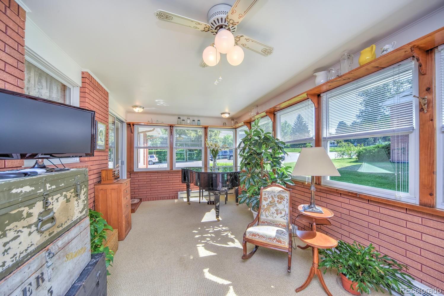 2219 Riviera Place Longmont, CO 80501 - Photo 10 of 19 a living room with patio furniture and a flat screen tv