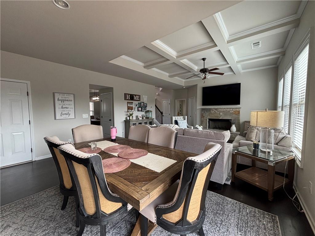 3459 In Bloom Way Auburn, GA 30011 - Photo 12 of 35 a dining room with furniture a rug and a chandelier