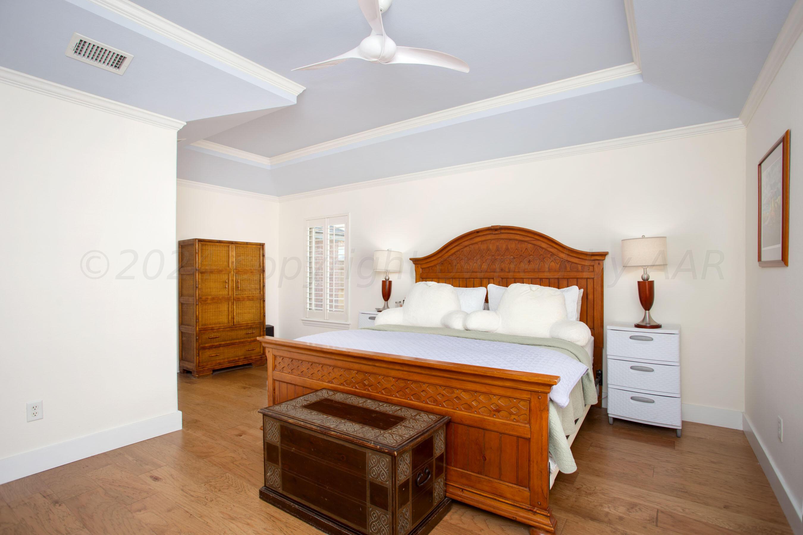 6921 Thunder Road Amarillo, TX 79119 - Photo 11 of 28 a bedroom with a bed and a closet