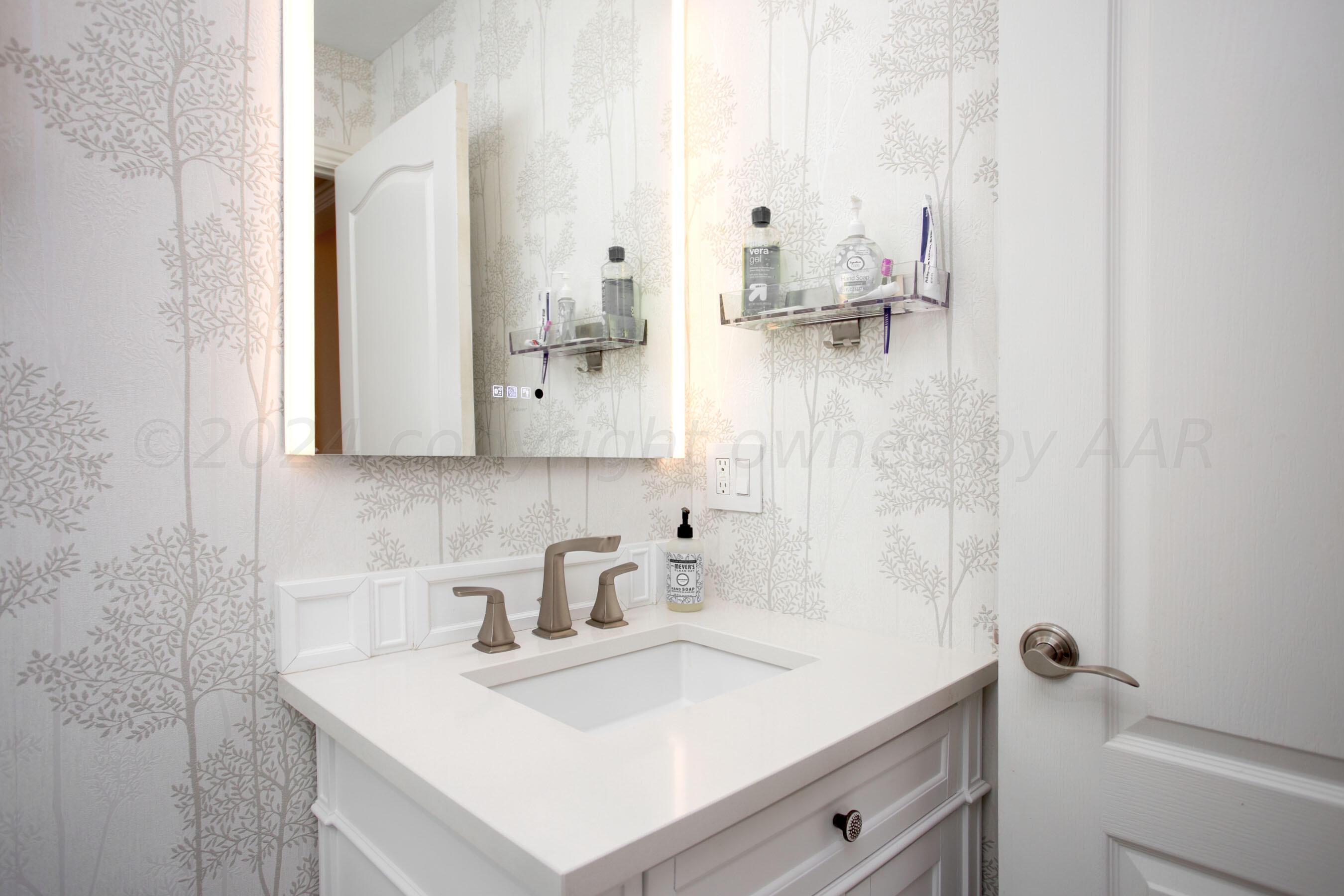 6921 Thunder Road Amarillo, TX 79119 - Photo 18 of 28 a bathroom with a sink vanity and a mirror