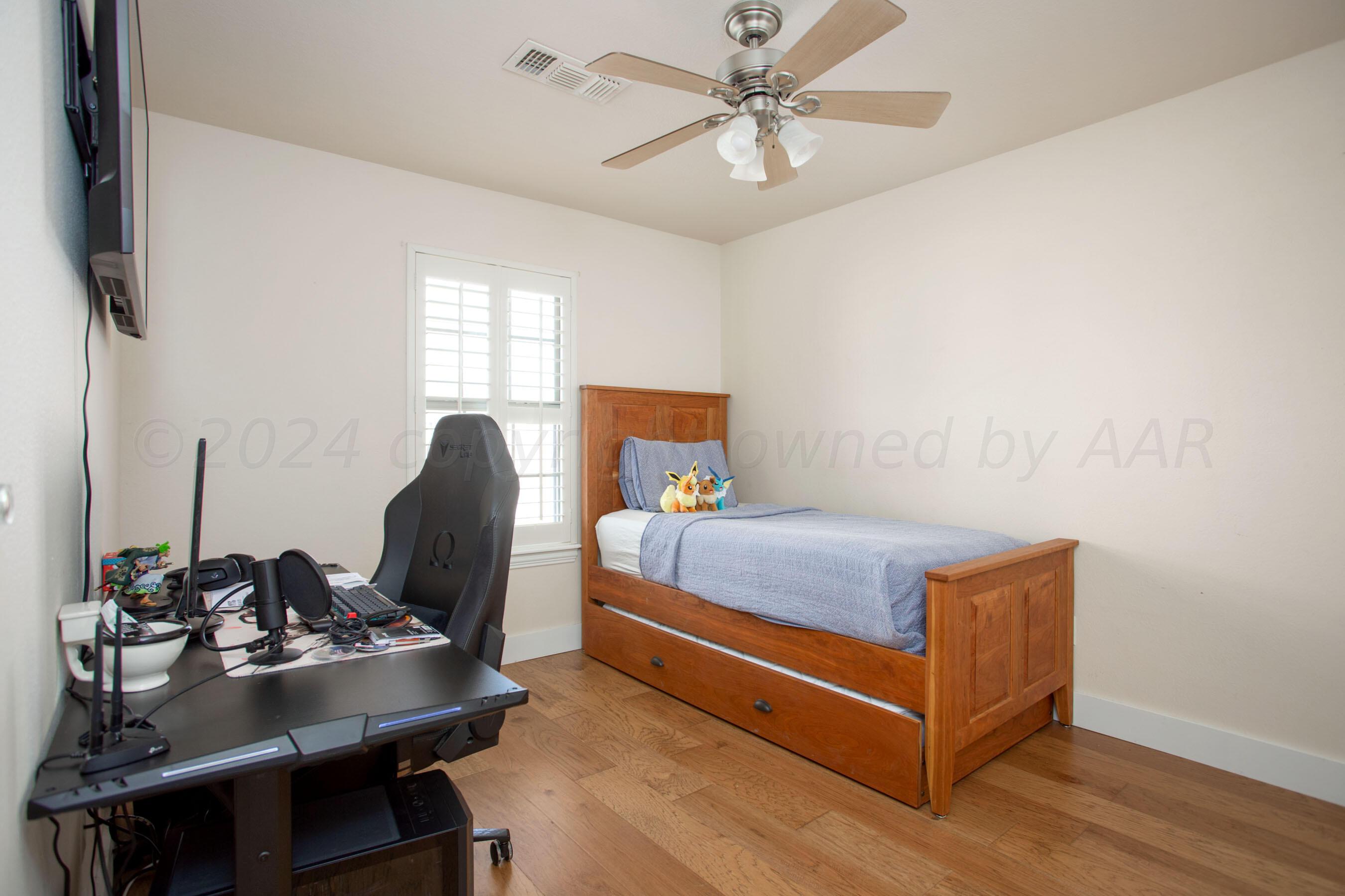 6921 Thunder Road Amarillo, TX 79119 - Photo 22 of 28 a bedroom with a bed and a desk