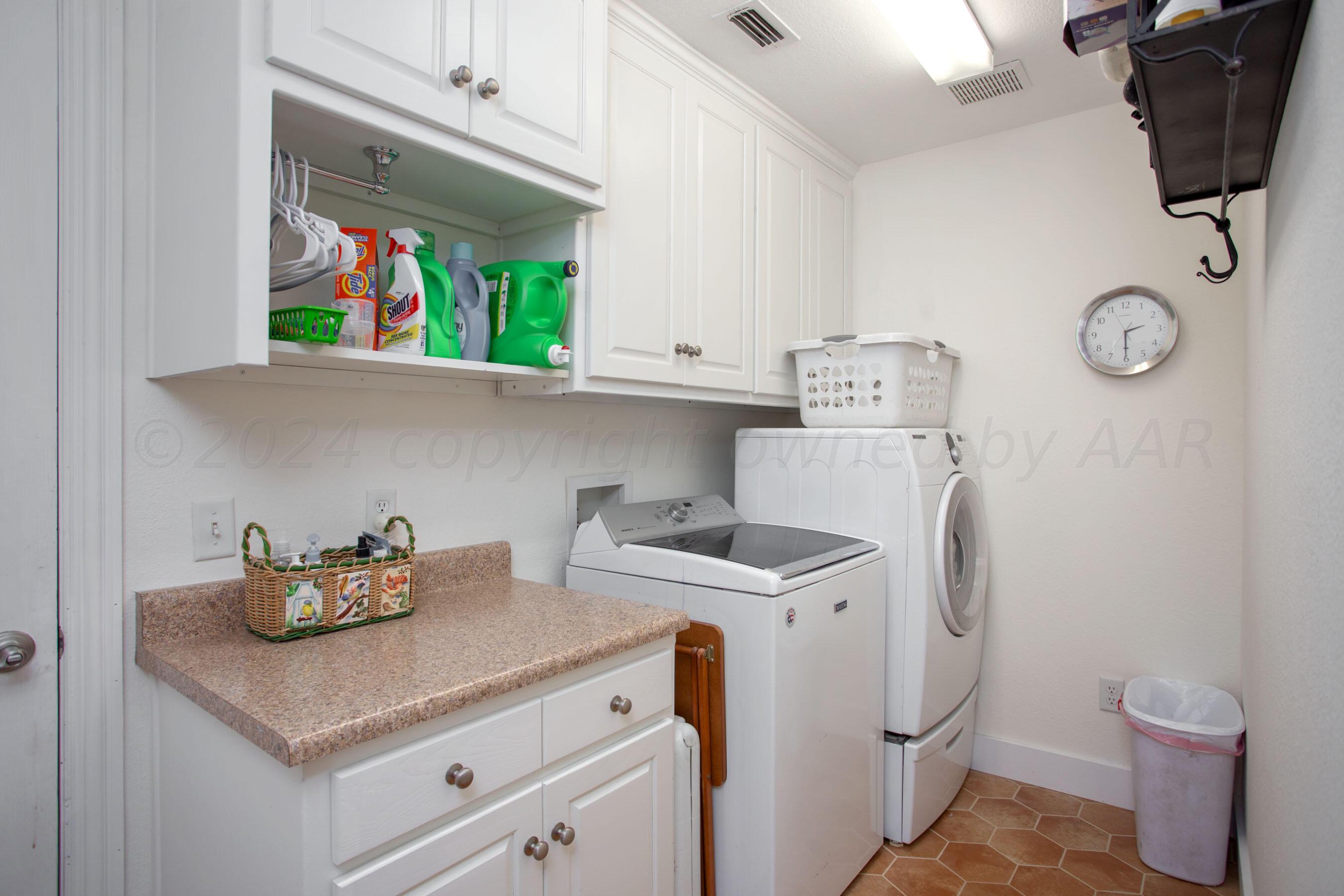 6921 Thunder Road Amarillo, TX 79119 - Photo 23 of 28 a kitchen with a stove and a white refrigerator