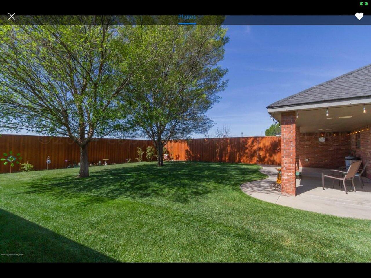 6921 Thunder Road Amarillo, TX 79119 - Photo 24 of 28 a view of a backyard with large tree