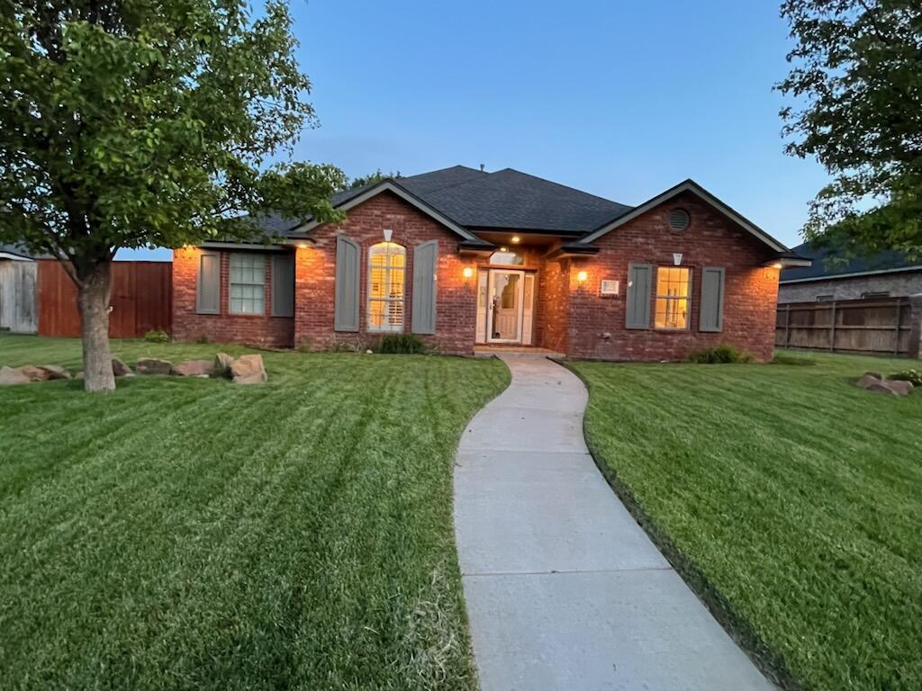 6921 Thunder Road Amarillo, TX 79119 - Photo 28 of 28 a front view of a house with a yard and garage
