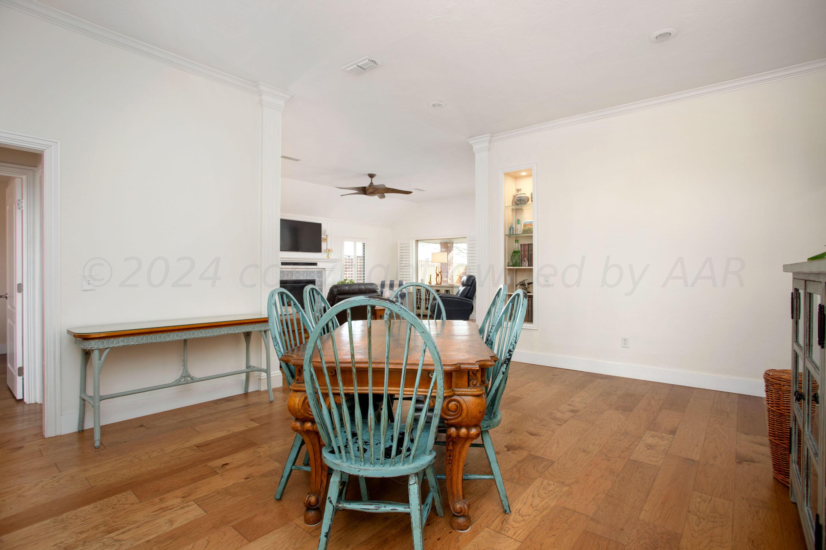6921 Thunder Road Amarillo, TX 79119 - Photo 3 of 28 a view of a dining room with furniture and wooden floor