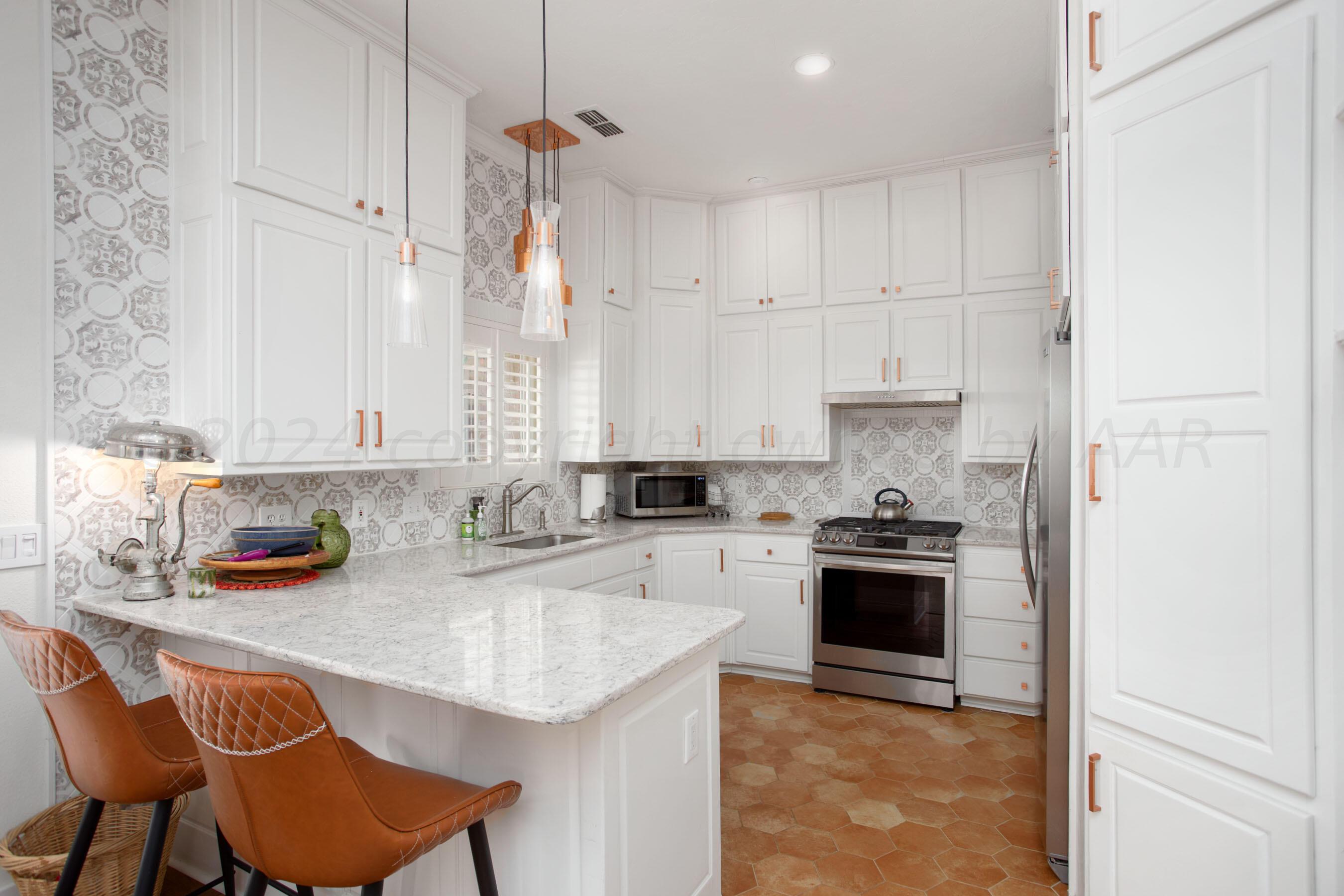 6921 Thunder Road Amarillo, TX 79119 - Photo 4 of 28 a kitchen with stainless steel appliances granite countertop a sink stove and refrigerator