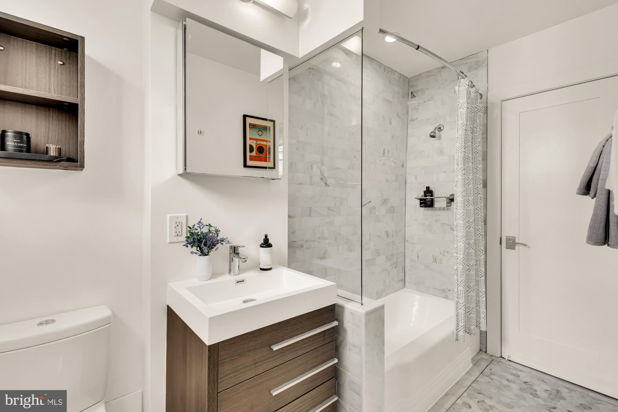 1910 Kalorama Road Northwest, Unit 302 Washington, DC 20009 - Photo 20 of 28 a bathroom with a sink toilet and shower
