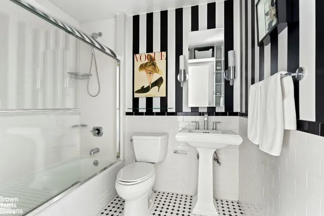 a bedroom with a bed a mirror and a window