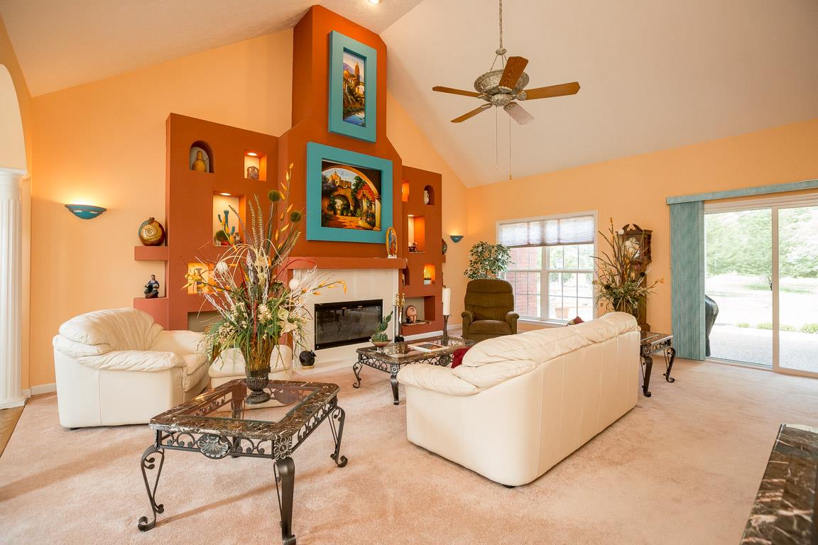 1066 Harkreader Road Mount Juliet, TN 37122 - Photo 12 of 30 a living room with furniture a fireplace and a chandelier