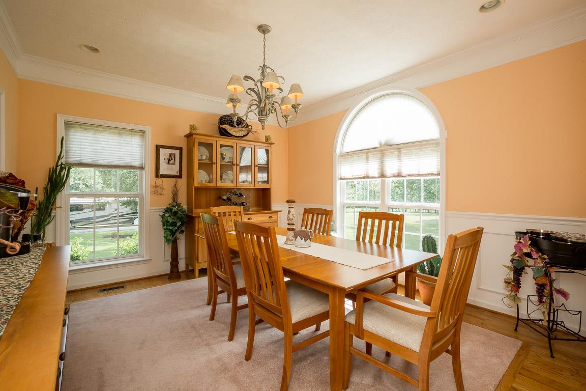 1066 Harkreader Road Mount Juliet, TN 37122 - Photo 15 of 30 a view of a dining room with furniture a chandelier and wooden floor