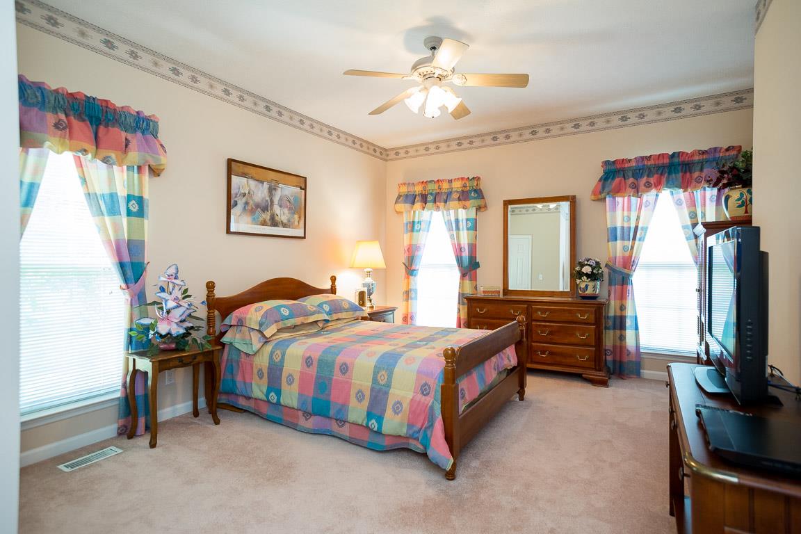 1066 Harkreader Road Mount Juliet, TN 37122 - Photo 25 of 30 a bedroom with a bed and a flat screen tv