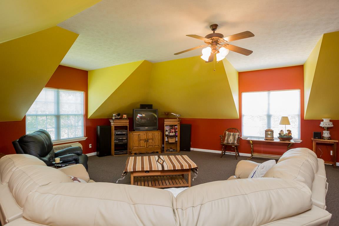1066 Harkreader Road Mount Juliet, TN 37122 - Photo 28 of 30 a living room with furniture a chandelier and a large window