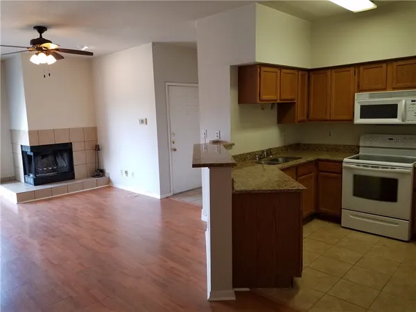 a kitchen with a stove a refrigerator and a microwave