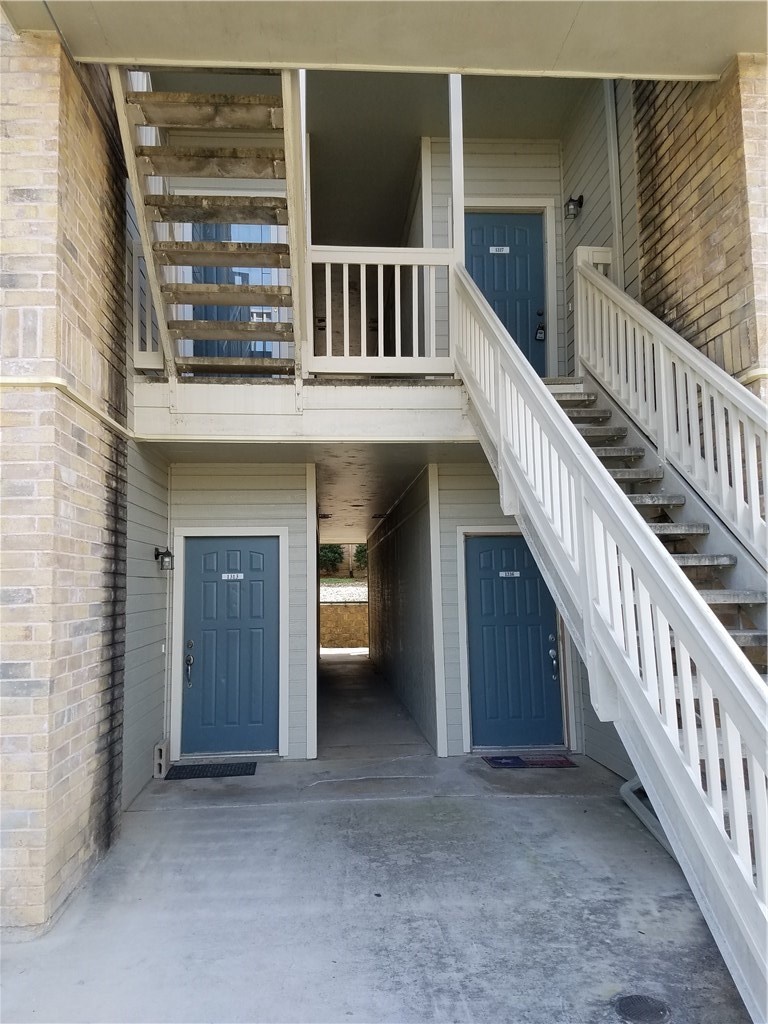 2450 Wickersham Lane, Unit 1317 Austin, TX 78741 - Photo 16 of 20 a view of a porch with wooden floor and stairs