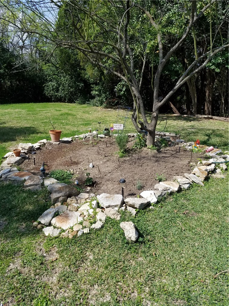 2450 Wickersham Lane, Unit 1317 Austin, TX 78741 - Photo 18 of 20 a backyard of a house with a yard and outdoor seating