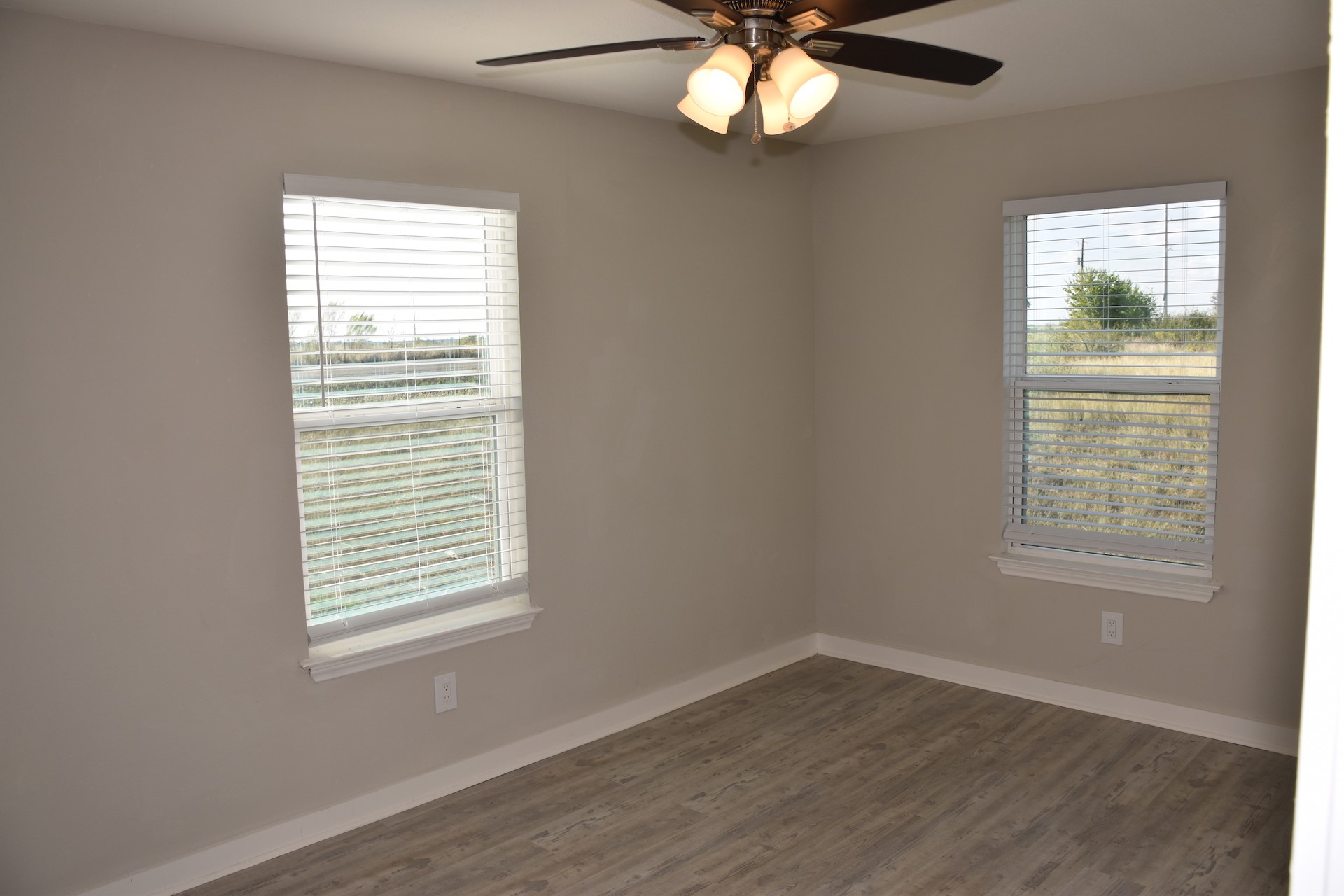 3751 County Road 463 Elgin, TX 78621 - Photo 21 of 27 a view of an empty room with wooden floor and a window