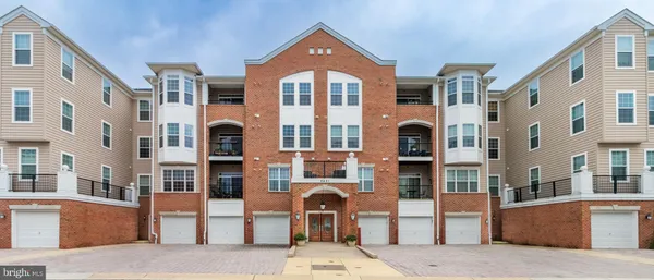 a front view of a residential apartment building with a yard