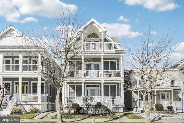 a front view of a residential apartment building with a yard