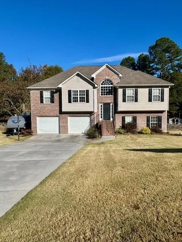 a front view of a house with a yard