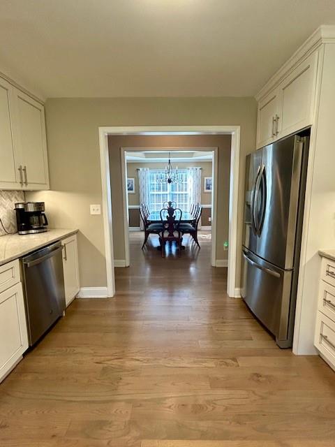 140 Washington Street Southeast Calhoun, GA 30701 - Photo 13 of 24 a kitchen with granite countertop a refrigerator a sink a stove and dining table