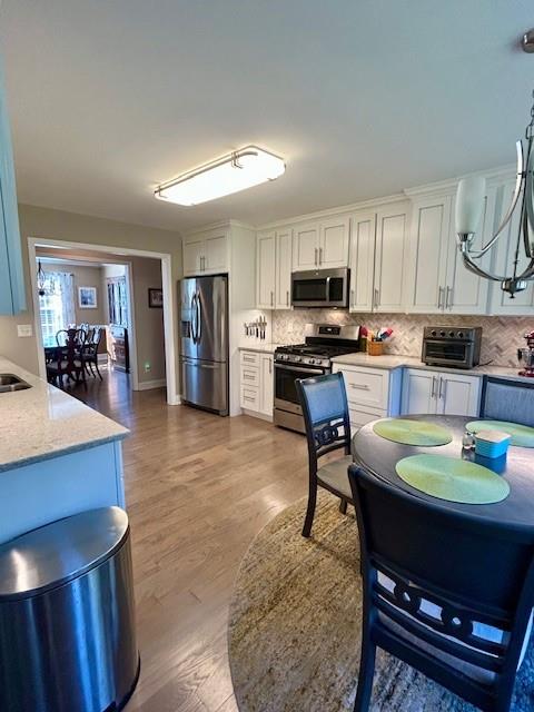 140 Washington Street Southeast Calhoun, GA 30701 - Photo 10 of 24 a kitchen with a dining table and chairs