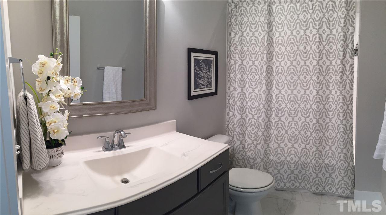 840 The Village Circle Raleigh, NC 27615 - Photo 14 of 17 a bathroom with a sink a toilet and a mirror