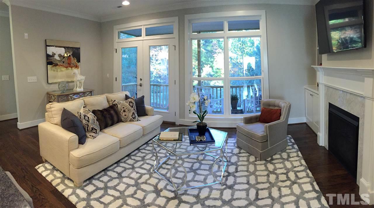 840 The Village Circle Raleigh, NC 27615 - Photo 3 of 17 a living room with furniture a fireplace and a floor to ceiling window