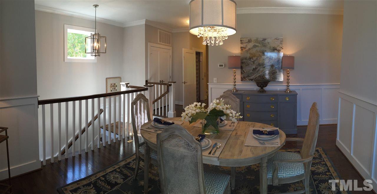 840 The Village Circle Raleigh, NC 27615 - Photo 4 of 17 a view of a dining room with furniture wooden floor and chandelier