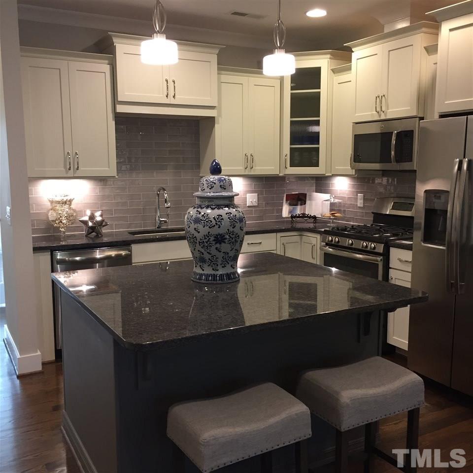 840 The Village Circle Raleigh, NC 27615 - Photo 5 of 17 a kitchen with stainless steel appliances granite countertop a sink a stove and a microwave