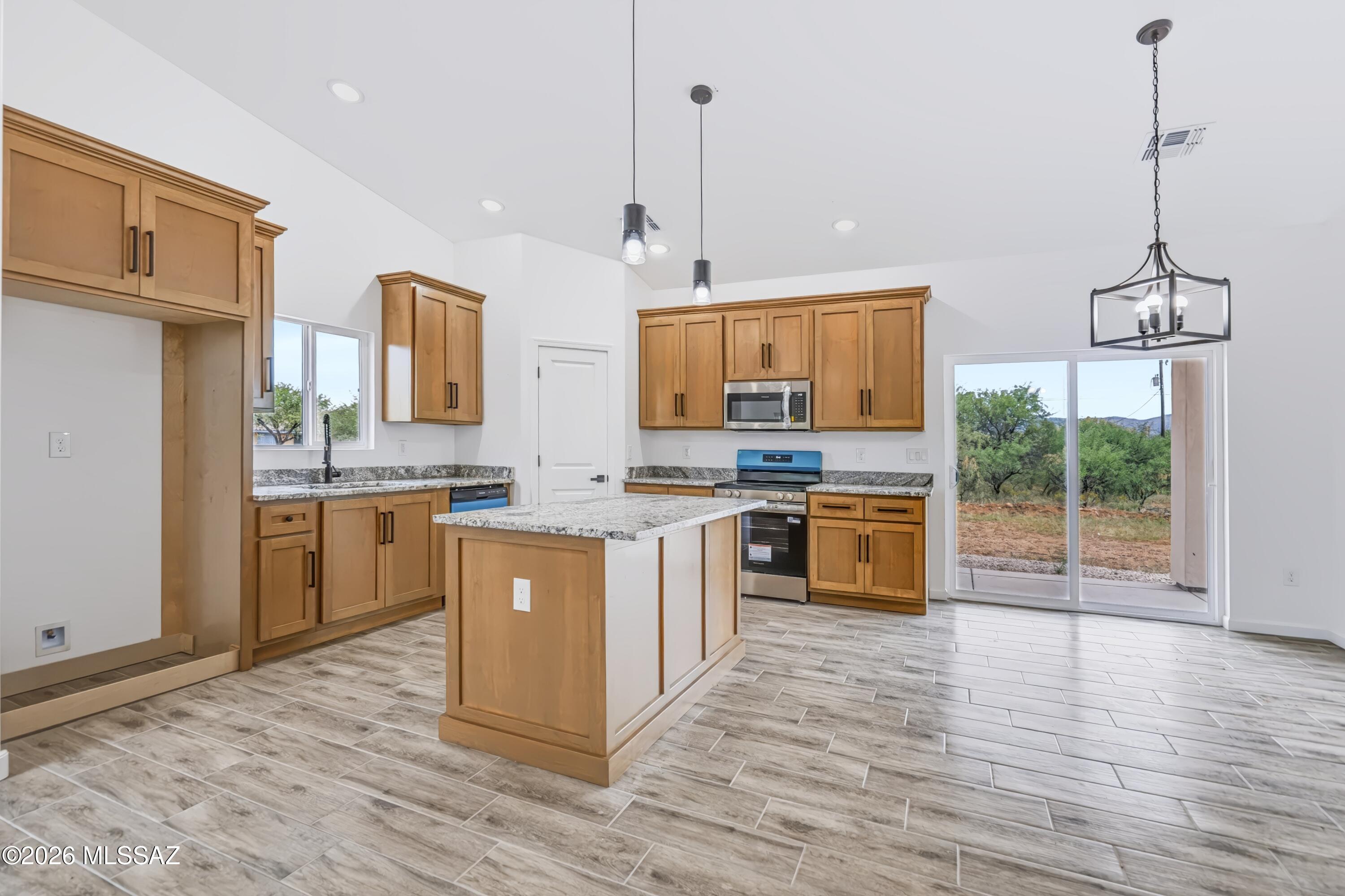 View of kitchen and island from the living room