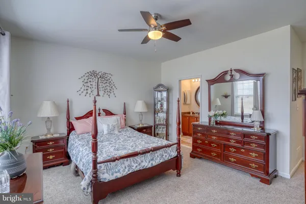 a bed room with a bed and a chandelier