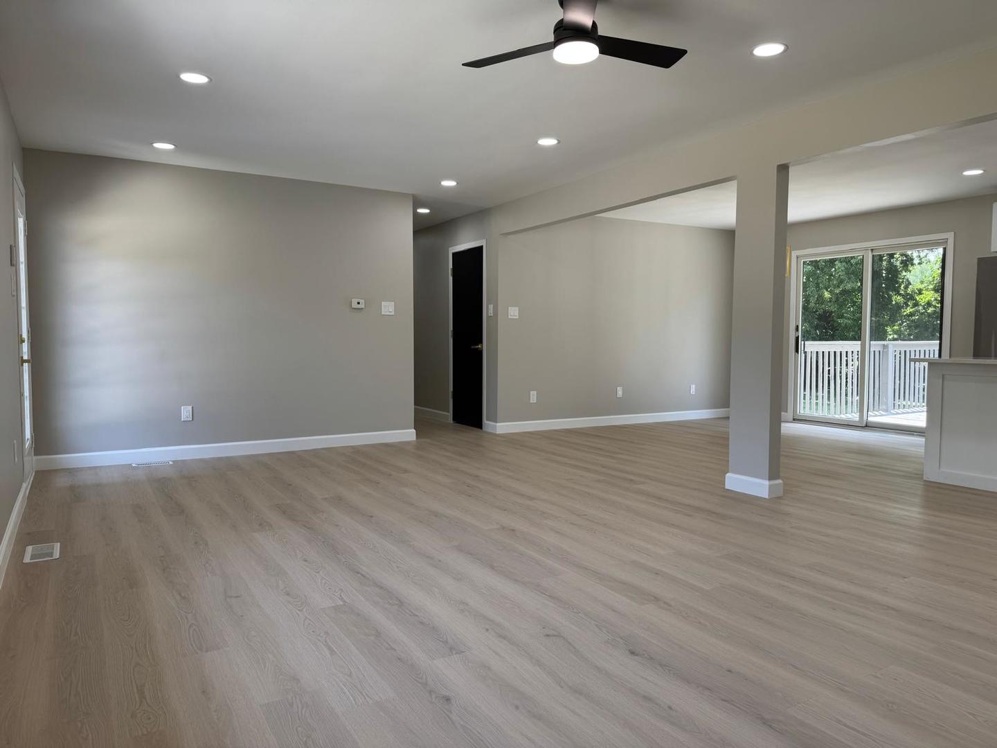 831 Richards Street Joliet, IL 60433 - Photo 13 of 31 an empty room with wooden floor fan and windows