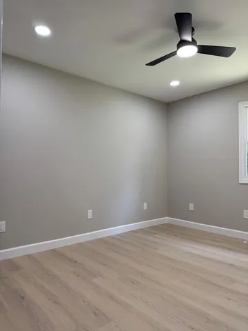 a view of room with a ceiling fan and window
