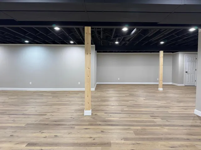 a view of a room with wooden floor
