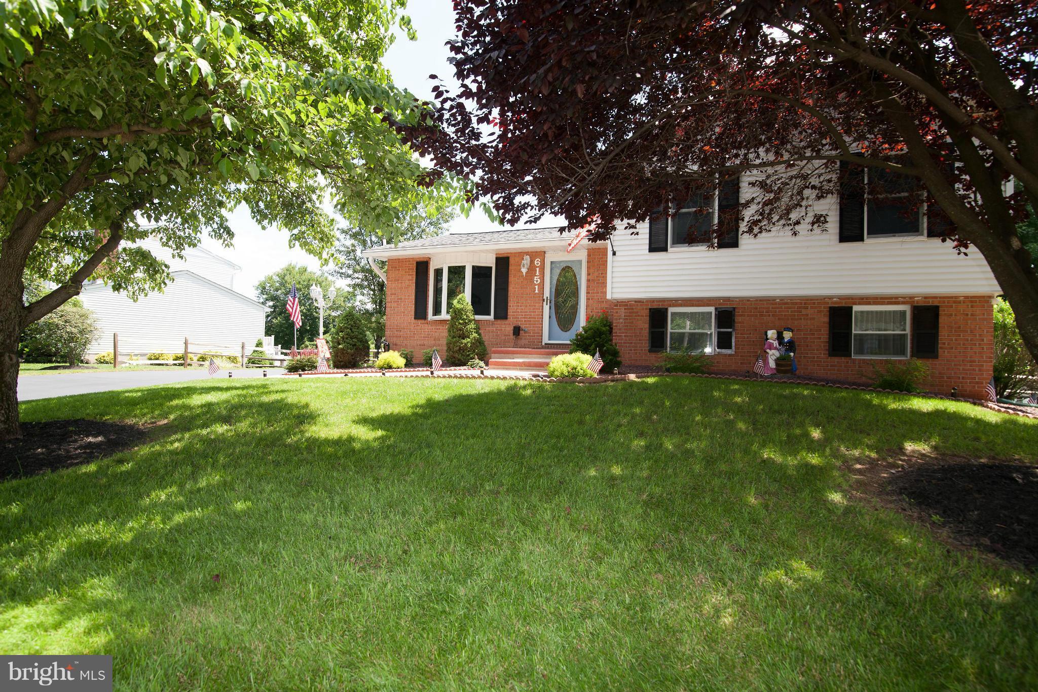 a front view of a house with a yard porch and sitting area