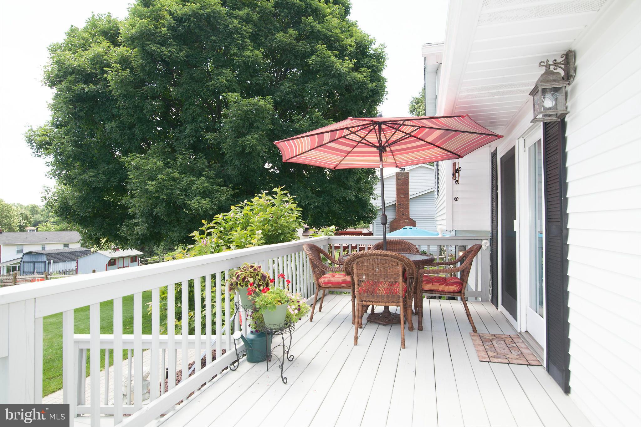 6151 Oklahoma Road Sykesville, MD 21784 - Photo 13 of 23 a view of a table and chairs on the deck