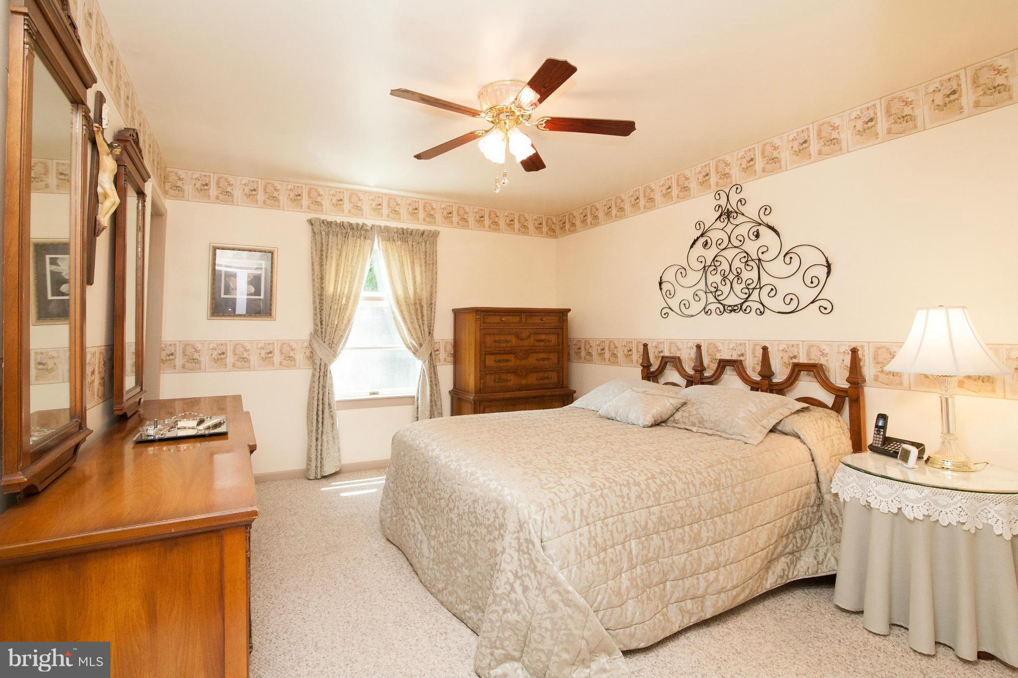6151 Oklahoma Road Sykesville, MD 21784 - Photo 6 of 23 a bedroom with a large bed and a chandelier